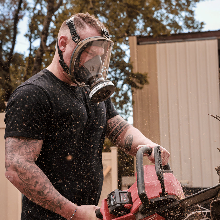 Man holding a chainsaw while wearing CM-I01