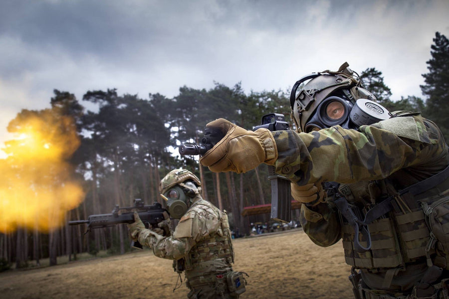 Soldiers firing rifles while using the CM-7M Military Gas Mask