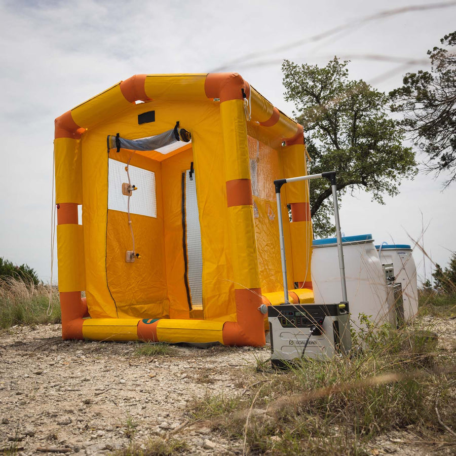 3/4 view of the decontamination shower with the water barrel and control box in view