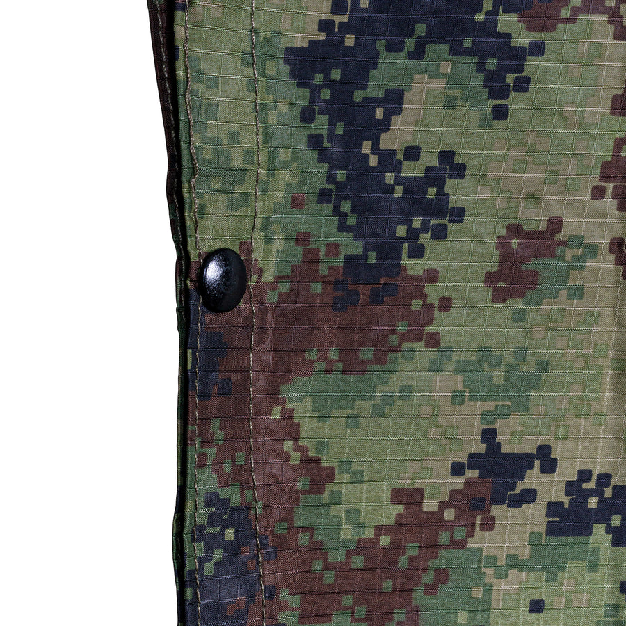 Close up of the grommets of M4 CBRN Military Poncho in the M-MDU-10 color scheme 